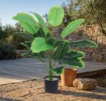 צמח עלים טרופיים מלאכותי בעציץ שחור